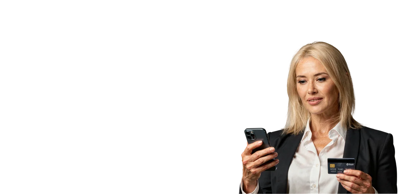 Businesswoman in a dark suit holding a smartphone and a payment card
