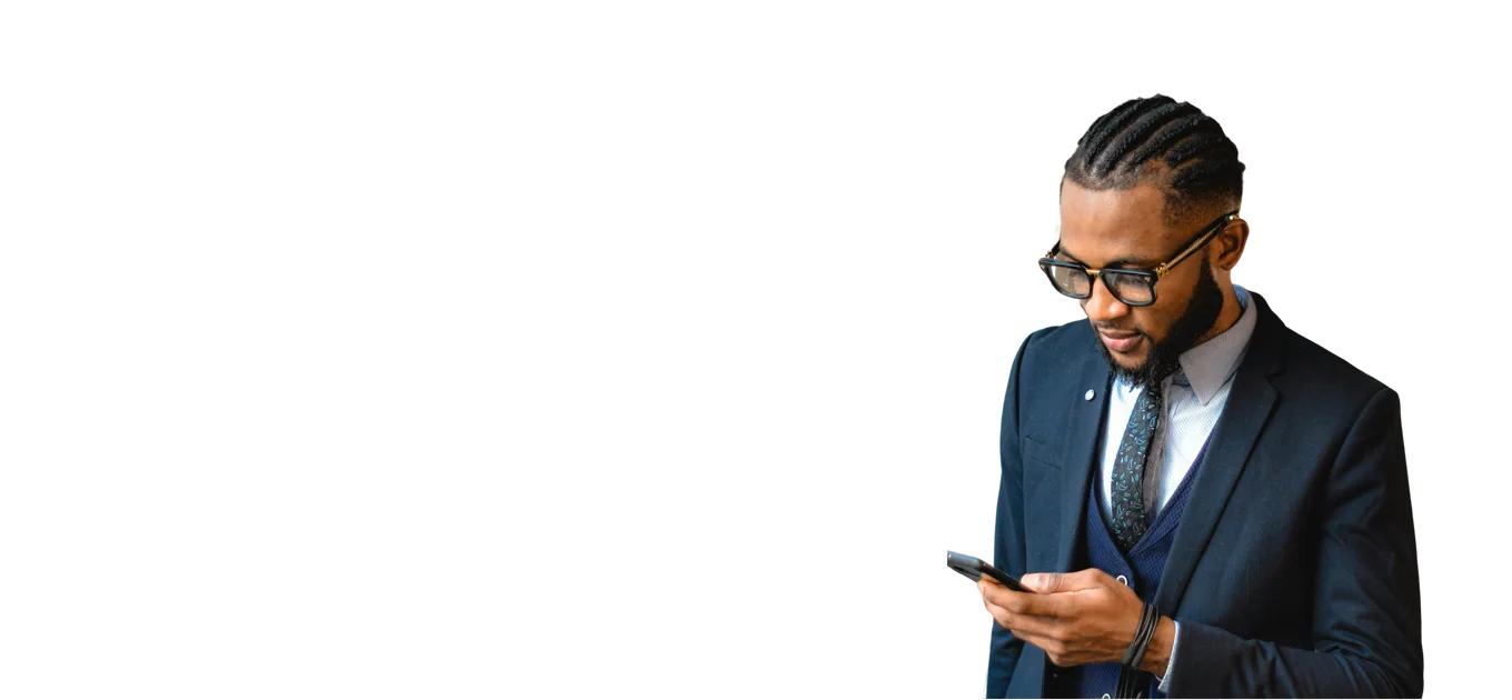 Man in a navy three-piece suit and glasses using a smartphone