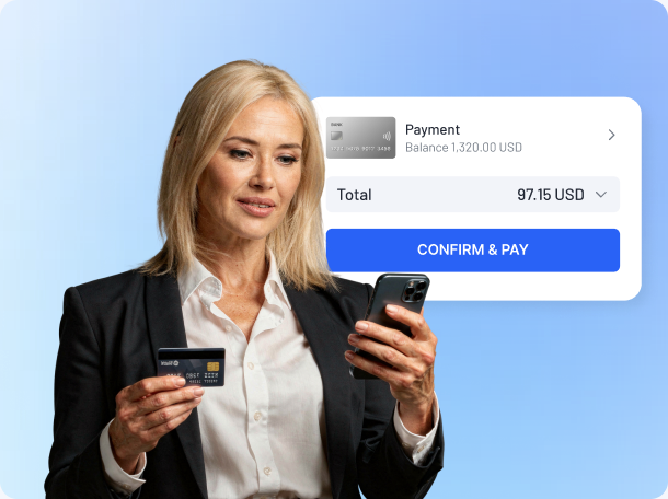 Woman holding a bank card while confirming a mobile payment in a banking app