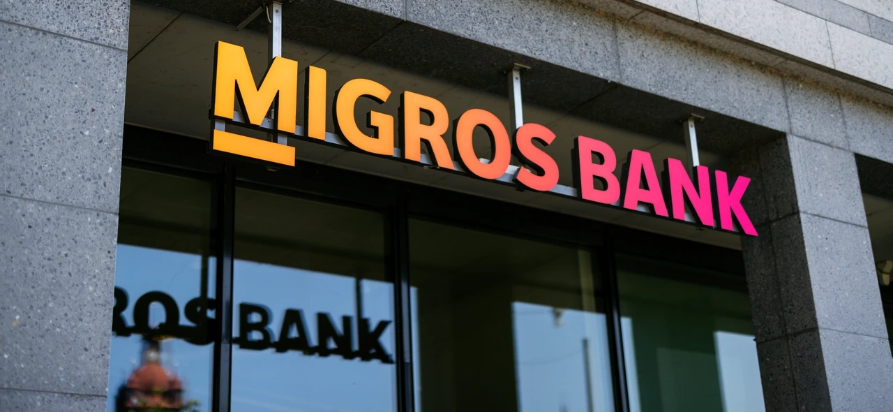 Migros Bank signage above a branch entrance
